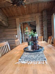 a table in a log cabin with a plant on it at Lovely log cabin at Lifjell in Lifjell