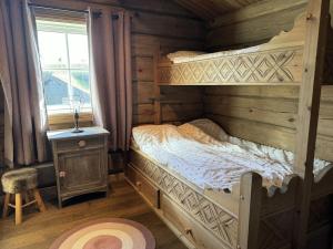a bedroom with a bunk bed in a log cabin at Lovely log cabin at Lifjell in Lifjell