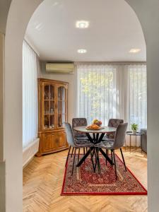a dining room with a table and chairs at 2BR Vintage Apt next to Tsar Simeon Garden by Flat Manаger in Plovdiv +24 photos