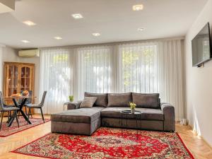 a living room with a couch and a table at 2BR Vintage Apt next to Tsar Simeon Garden by Flat Manаger in Plovdiv