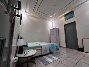 a bedroom with a bed and a table with a lamp at Les Résidences de Cobat in Kika