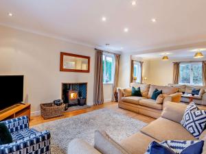 a living room with two couches and a fireplace at 5 Bed in Witherslack SZ593 in Levens