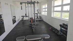a room with a gym with exercise equipment in it at Ocean Paradise Luxury in Nikawatawana