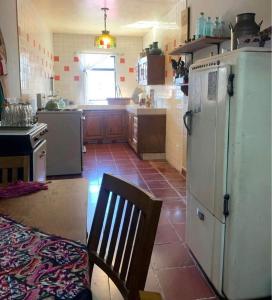 een keuken met een koelkast en een stoel. bij Habitación in Morelia