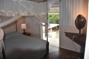 a bedroom with a bed and a large window at appartamento bella vista cratere in Nosy Be +54 photos