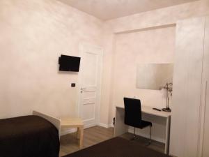 a bedroom with a desk and a bed and a chair at Crocco D'Oro in Caltavuturo