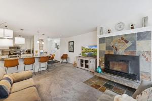 a living room with a couch and a fireplace at Silvertown Powder Pad-on Park Ave Steps to Slopes Shops and Dining in Park City