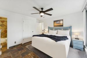 a bedroom with a bed and a ceiling fan at Silvertown Powder Pad-on Park Ave Steps to Slopes Shops and Dining in Park City