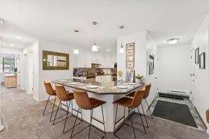 a kitchen and dining room with a table and chairs at Silvertown Powder Pad-on Park Ave Steps to Slopes Shops and Dining in Park City