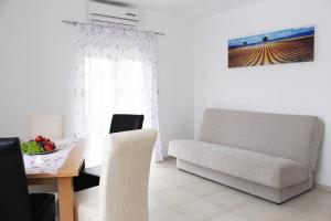 a living room with a couch and a table at Apartments Bella in Vodice +37 photos