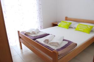 a bedroom with a bed with towels on it at Apartments Bella in Vodice