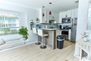 a kitchen with white cabinets and a counter top at Summer Breeze D212 - Bungalow 6 in Destin
