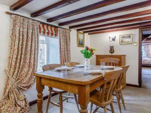 a dining room with a wooden table and chairs at 3 Bed in Newquay 82369 in Mitchell
