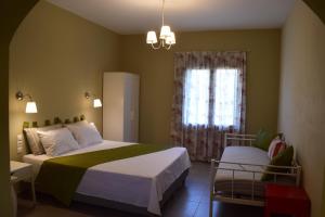 a bedroom with a large bed and a window at Kallisti Seaside Studios Skopelos in Agnontas