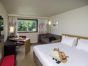 Ένα ή περισσότερα κρεβάτια σε δωμάτιο στο Novotel Nantes Carquefou