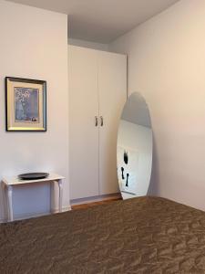 a bedroom with a bed with a surfboard on the wall at Apartment in Prishtina, Kosovo in Pristina