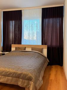 a bedroom with a bed and a large window at Apartment in Prishtina, Kosovo in Pristina