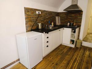 a kitchen with a sink and a counter top at Apartment B B B in Český Krumlov