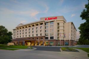 a large white hotel with a martinant sign on it at Denver Airport Marriott at Gateway Park in Aurora
