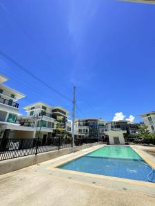 a swimming pool in front of some apartment buildings at Malibu Lanang SMX convention nearby Full house in Davao City