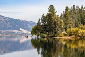 a view of a lake with trees on the shore at Holiday Inn Express & Suites Kelowna - East by IHG in Kelowna