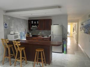 a kitchen with a counter and a refrigerator at Aptos Sunrise Beach in San Andrés