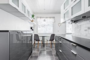 a kitchen with a table and chairs in it at Santa's choice for Aurora hunters , Sauna and jacuzzi in Rovaniemi