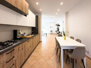 a kitchen with a table and a white counter top at Jazz & Blues Apartments near " Sentiero degli Dei " in Agerola