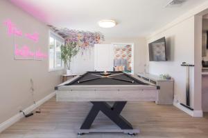 a ping pong table in a room with at Reseda 4BR Pool Villa Hot Tub Arcade & Biliard in Winnetka