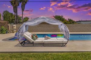 a bed in a gazebo next to a pool at Reseda 4BR Pool Villa Hot Tub Arcade & Biliard in Winnetka