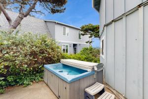a hot tub sitting next to a building at Neptune's Trident in Lincoln Beach