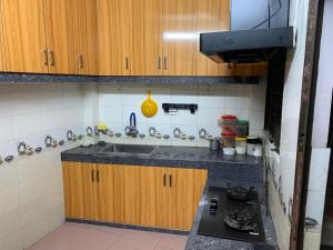 a small kitchen with a sink and a stove at Dream Palace in Sylhet +4 photos