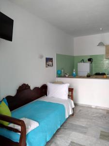 a bedroom with a bed with a blue blanket at Glaros Beach in Perivolos +41 photos
