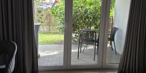 an open door to a patio with a table and chairs at Apartament Wenecja z ogródkiem,parking in Ostrów Wielkopolski