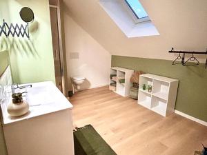 a bathroom with a sink and a toilet and a skylight at Superb studio Malo-les-Bains in Dunkerque +13 photos