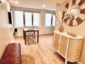 a living room with a table and a couch at Superb studio Malo-les-Bains in Dunkerque