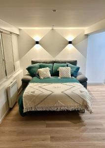 a bedroom with a bed with two pillows on it at Superb studio Malo-les-Bains in Dunkerque