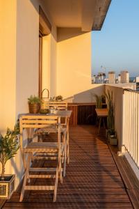 a patio with a table and chairs on a balcony at Luxurious 3 Bedrooms Sauna Jacuzzi in Tinqueux