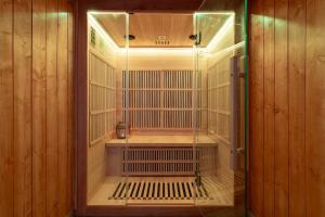 an empty cage in a room with wooden walls at Luxurious 3 Bedrooms Sauna Jacuzzi in Tinqueux