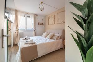 a bedroom with a white bed and a plant at Luxurious 3 Bedrooms Sauna Jacuzzi in Tinqueux +17 photos