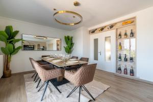 a dining room with a table and chairs at Luxurious 3 Bedrooms Sauna Jacuzzi in Tinqueux