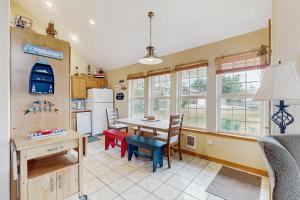 a kitchen and dining room with a table and chairs at Windsong in Rockaway Beach
