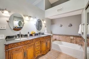 a bathroom with a tub and a sink and a tub and a mirror at Fenced-In Yard Home Less Than 1 Mi to Lake Ray Hubbard! in Faulkner Point Heliport +22 photos