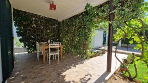 a dining room with an ivy covered wall at MY DALMATIA - Holiday home Franka near the beach in Jadrija +26 photos