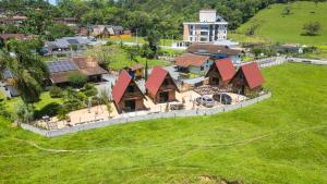 an aerial view of a house on a green field at Chalés Pomertraum in Pomerode
