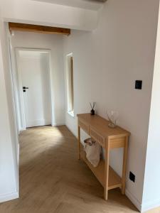 a room with a wooden table and a hallway at Szałas na Hałas in Lubiana