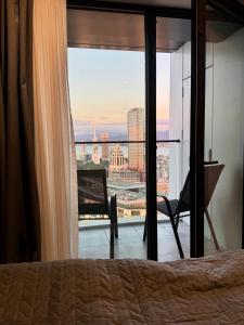 a bedroom with a bed and a view of the city at Apartment with sea View in Itʼkhvisi