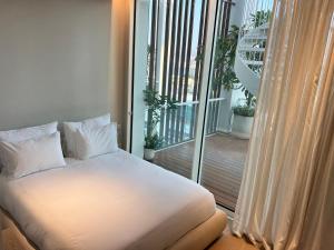 a bed in a room with a balcony at Queen of the Red Sea Eilat Crown Group Collection in Eilat +21 photos