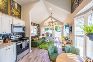 a kitchen and living room with a table and chairs at Rainforest Tiny Home Retreat Enchanted in Forks