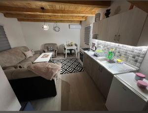 a kitchen and living room with a couch and a table at Holiday Home AZER in Visoko